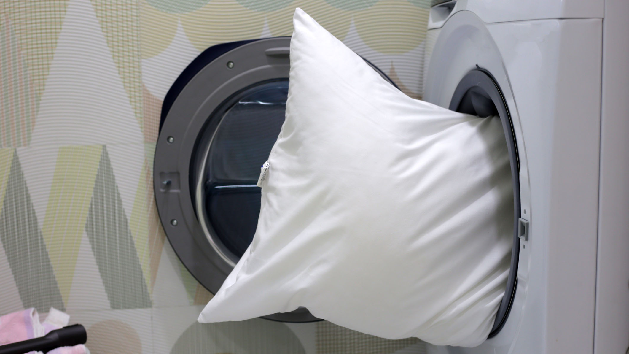 Reading the care label on a new pillow before washing it