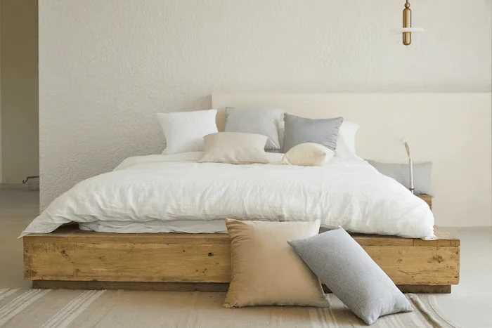 Queen bed pillow arrangement with sleeping pillows shams and a front accent