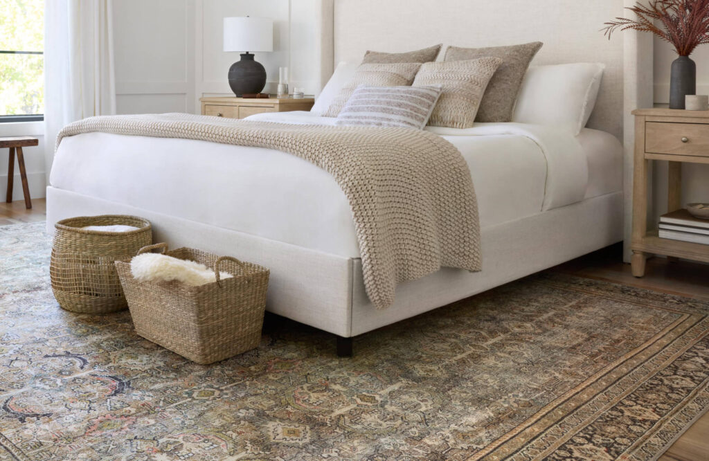 How many pillows on a queen bed shown in a balanced layered arrangement