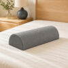 Grey half-moon bolster pillow on warm ivory bedding