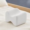 White contoured memory foam knee pillow with textured cover