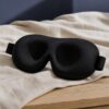 Close view of the contoured eye cups on a black sleep mask
