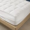 Close view of quilted mattress protector and deep fitted skirt