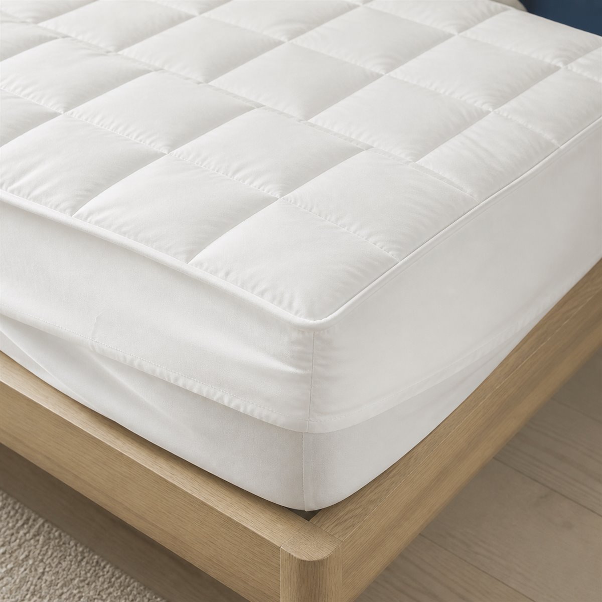 Close view of quilted mattress protector and deep fitted skirt